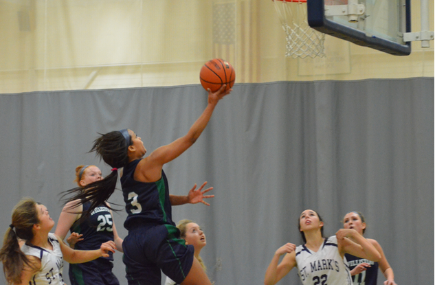 Captain Natalia Baum '15 goes up for a lay-up  in the game against St. Marks.
