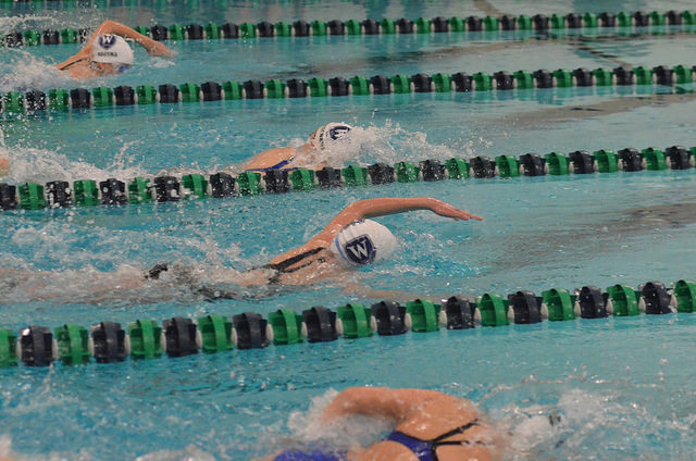 Girls Varsity Swimming in a meet against Worcester Academy. 