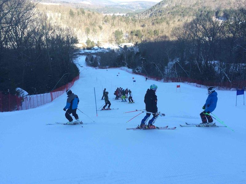 Varsity Boys Skiing members inspect the slalom course before the race with Coach Ray DeVerry. From left to right: Ted Carellas ’15, Devin DeVerry ’17, and Oliver Lawrence ’18.