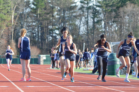 Sideya Dill '16 passes the baton to Brittany Engleman '15 in the 4x4 relay.