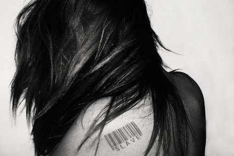 Photo of a girl with a barcode on her back displaying that she is "for sale"