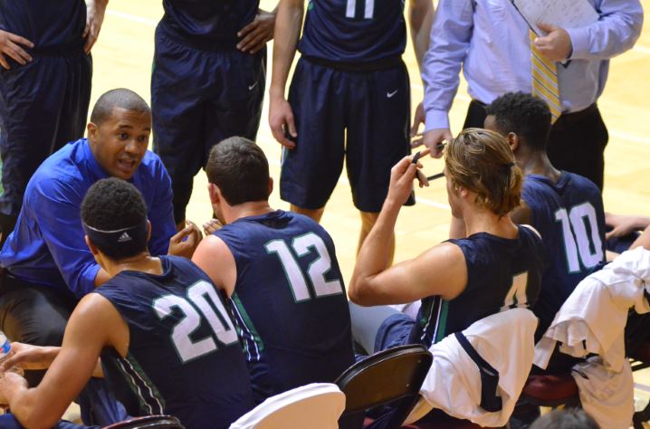 Coach Michael Shelton guiding his team during a time out when playing a game at UMass. 