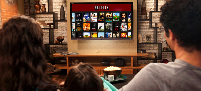 Photo of a family watching Netflix together.