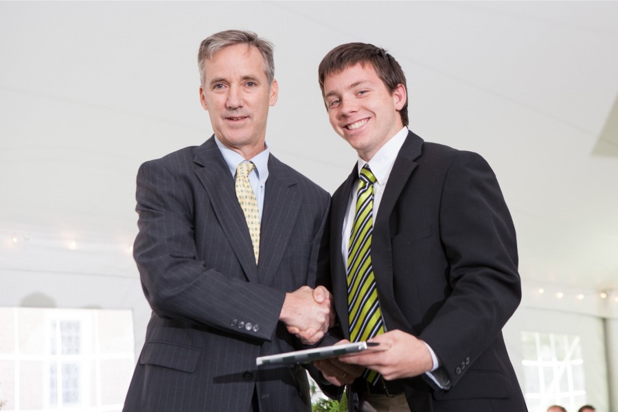 Sam Canney '16 shakes Mr. Hills hand as he receives an academic award.