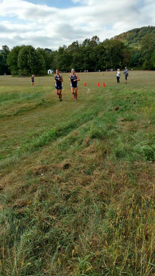 The girls cross country team running on their home course.