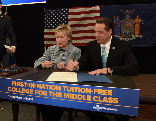 New York Governor Andrew Cuomo, joined by Hillary Clinton, enacts legislation offering free tuition to New York college students. Credit: Governor Cuomo's Flickr.