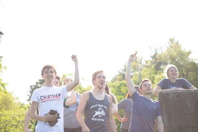 Nat Markey (left) cheering on fellow students in the canoe race on Willy Gras. 