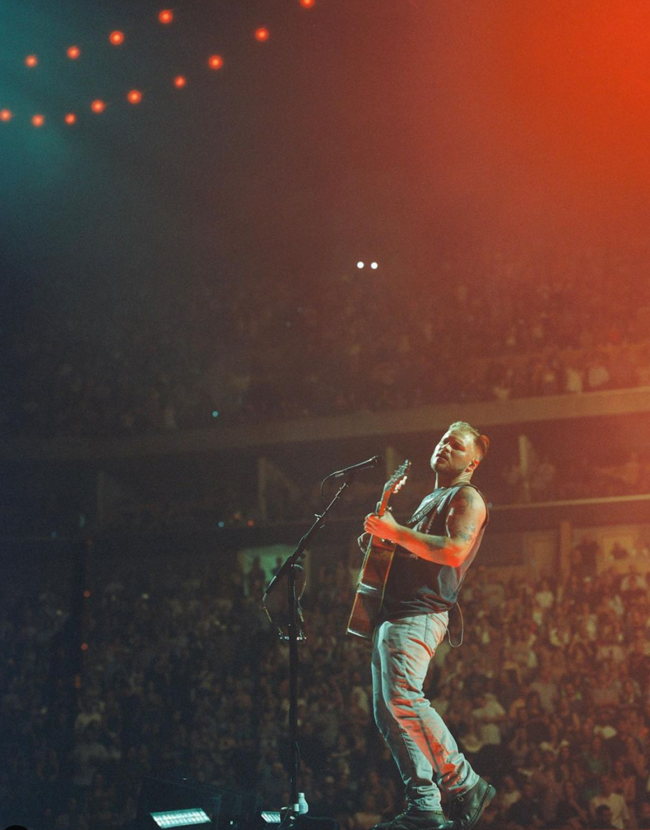 Zach Bryan plays guitar during a performance. Credit: Instagram