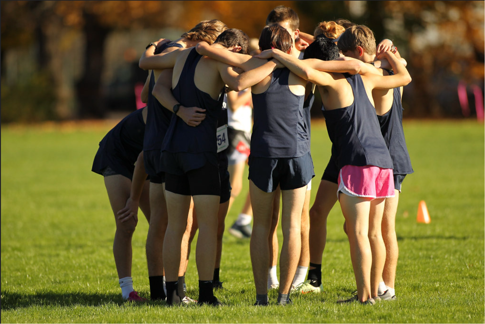 Members of the Boys Cross-Country Team gather for their chant prior to a home meet. Credit: Williston Flickr